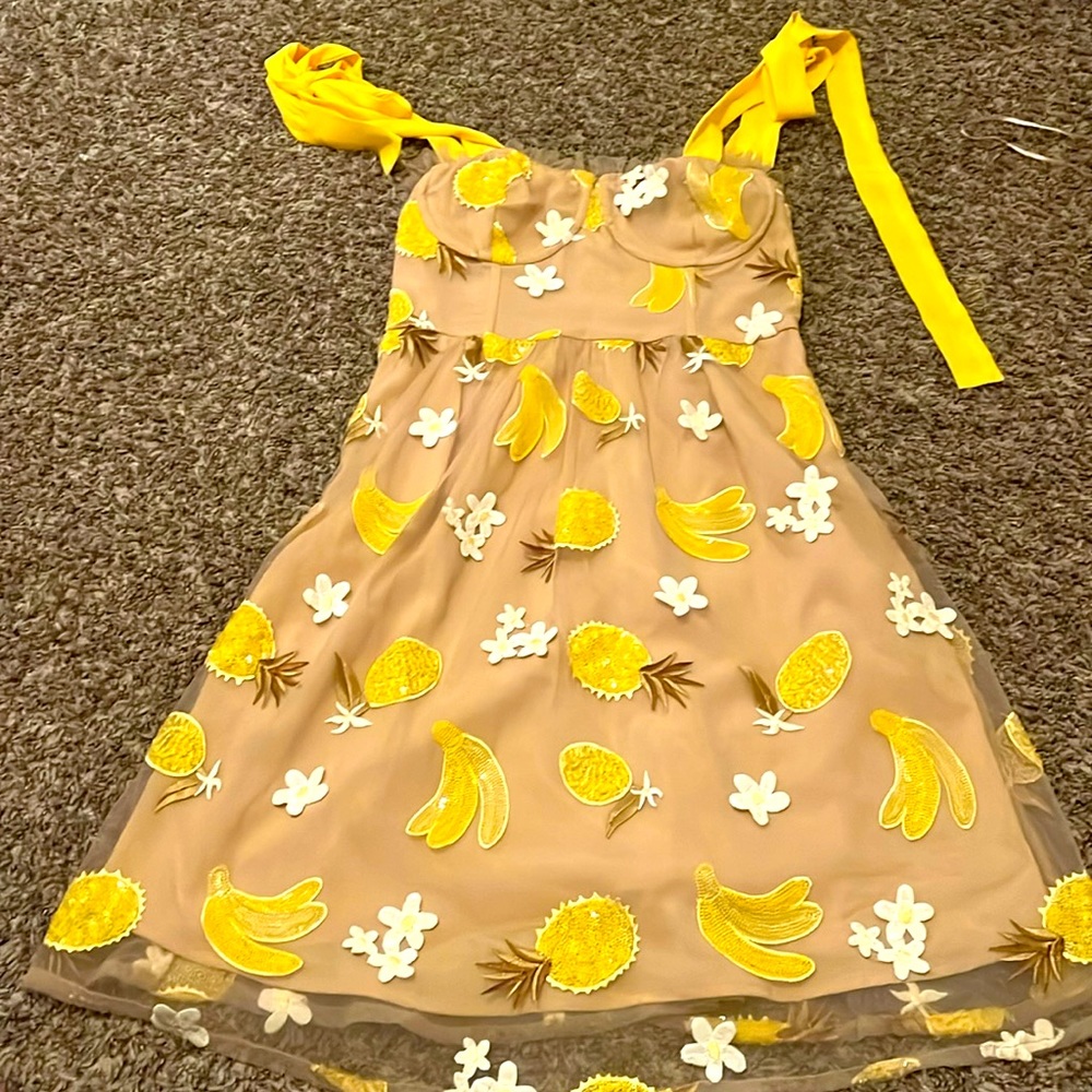 tan dress with flowers and yellow fruit